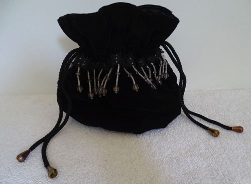 Drawstring purse of black velvet trimmed with beaded fringe and gimp.